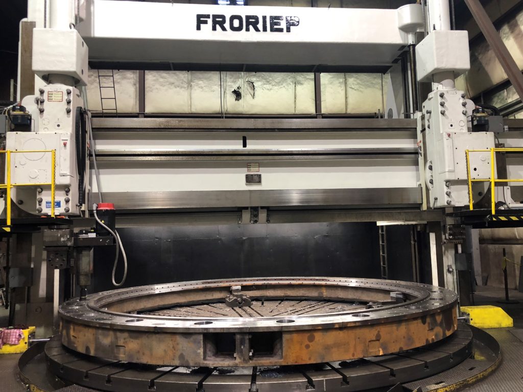 Hydro Electric turbine lower wicket gate bearing ring in Prime Machine shop Large Machining that includes line boring and facing of a lower wicket gate bearing ring on large vertical CNC machining center