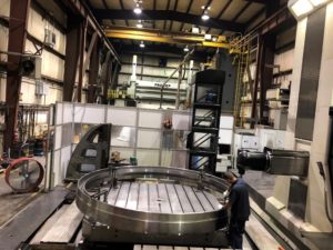Large machining centers in the machine shop. Large horizontal machining center with multiple heads and extreme accuracy over the entire machine volume. View of machine shop Machining large sealing ring with trained operators and programmers.